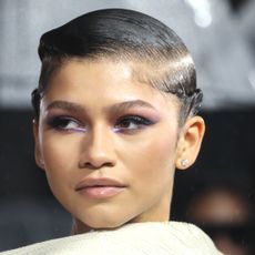 Zendaya attends the "Dune" UK Special Screening wearing purple eyeshadow on her brown eyes