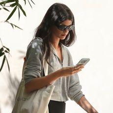 Kaia Gerber wearing a gray jacket with black leggings and Nike sneakers Los Angeles July 2024