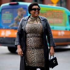 Gabriella Karefa-Johnson wearing a leopard print dress and a leather jacket 