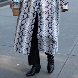 Nikki Ogunnaike wearing a snake-print coat, trousers, and boots