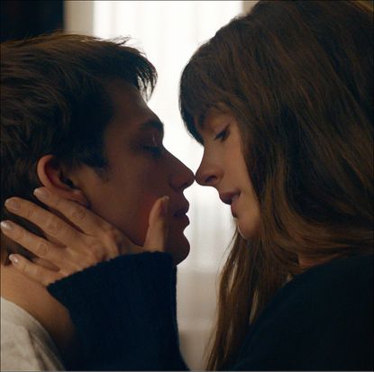 Nicholas Galitzine and Anne Hathaway, about to kiss in a hotel room, in 'The Idea of You'