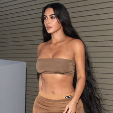 Kim Kardashian wears a MIU MIU designer Skirt and matching Crop top with PVC pleaser heels