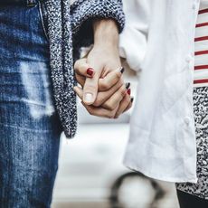 Two people holding hands