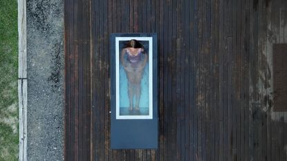 best cold plunge tub 2024 illustrated by a woman soaking in a cold plunge tub