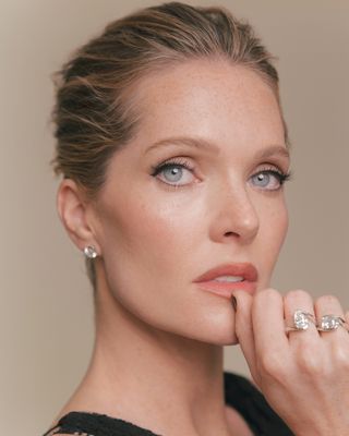 a close up of Meghann Fahy and her jewelry for the perfect couple premiere