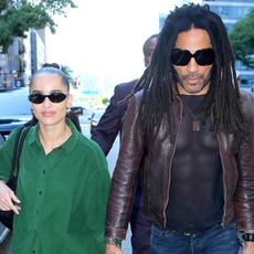 Zoë Kravitz with Lenny Kravitz wearing an oversized green button-up shirt with baggy jeans and black sneakers in New York City September 2024