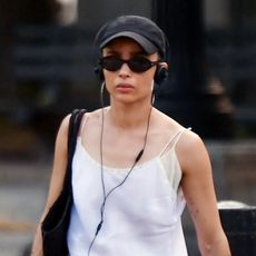 Zoë Kravitz wearing a white mini slip dress with white socks and black loafers in New York City June 2024