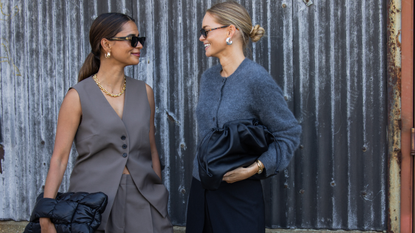 Emelie Lindmark wears grey vest, pants, black bag &amp; Claire Rose Cliteur wears grey cardigan, black bag, pants outside Cos during New York Fashion Week on September 10, 2024 in New York City.