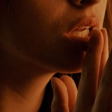 Woman provocatively touching her lips, scene from 'Fifty Shades of Grey'