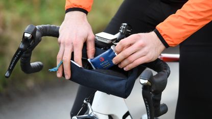 Image shows a rider using one of the best handlebar bags.