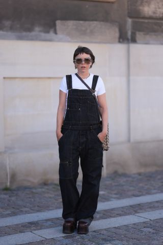 woman wearing overalls and a T-shirt