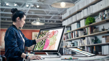 A woman working with the Surface Studio all-in-one