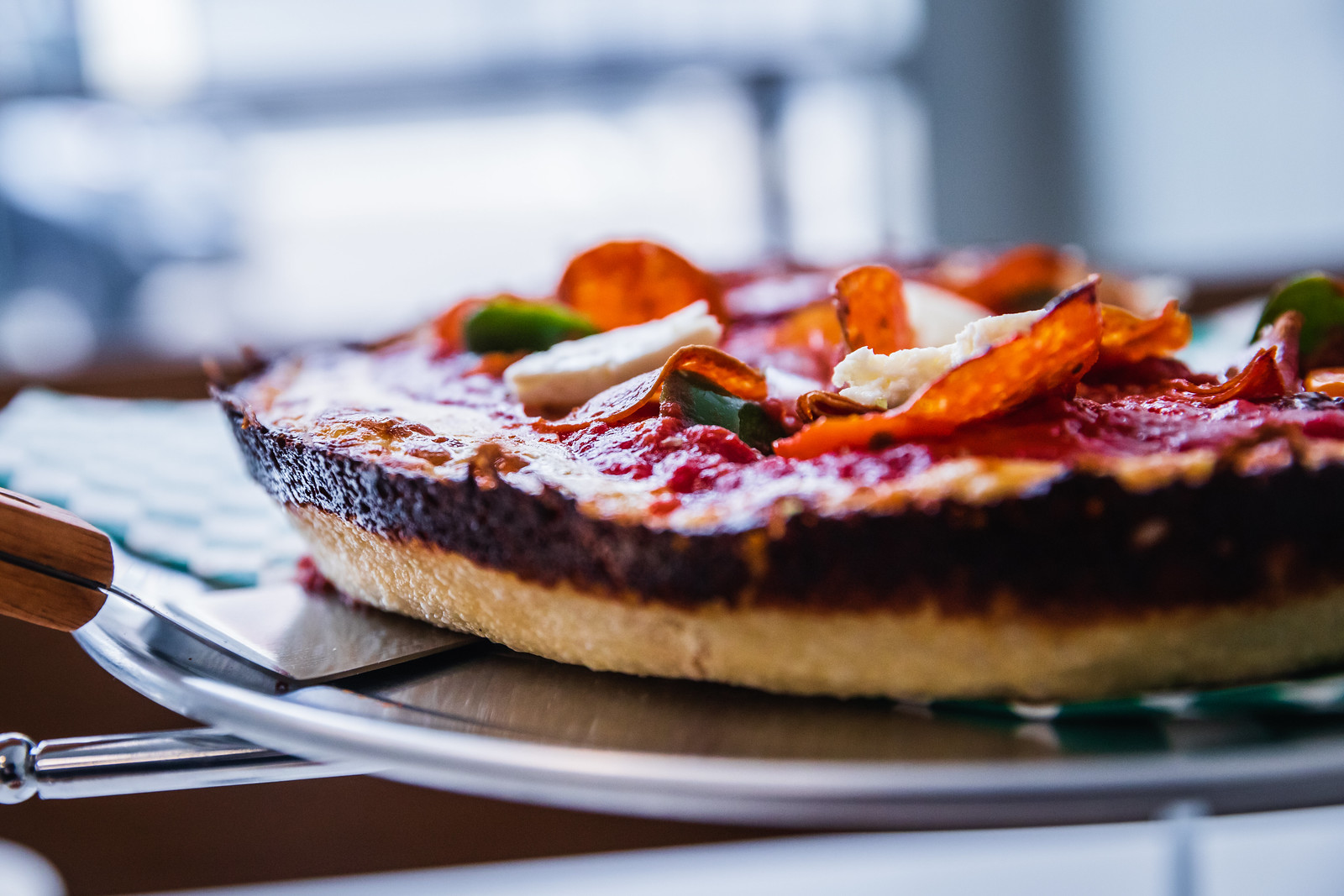 A close up of deep dish pizza from the crust.