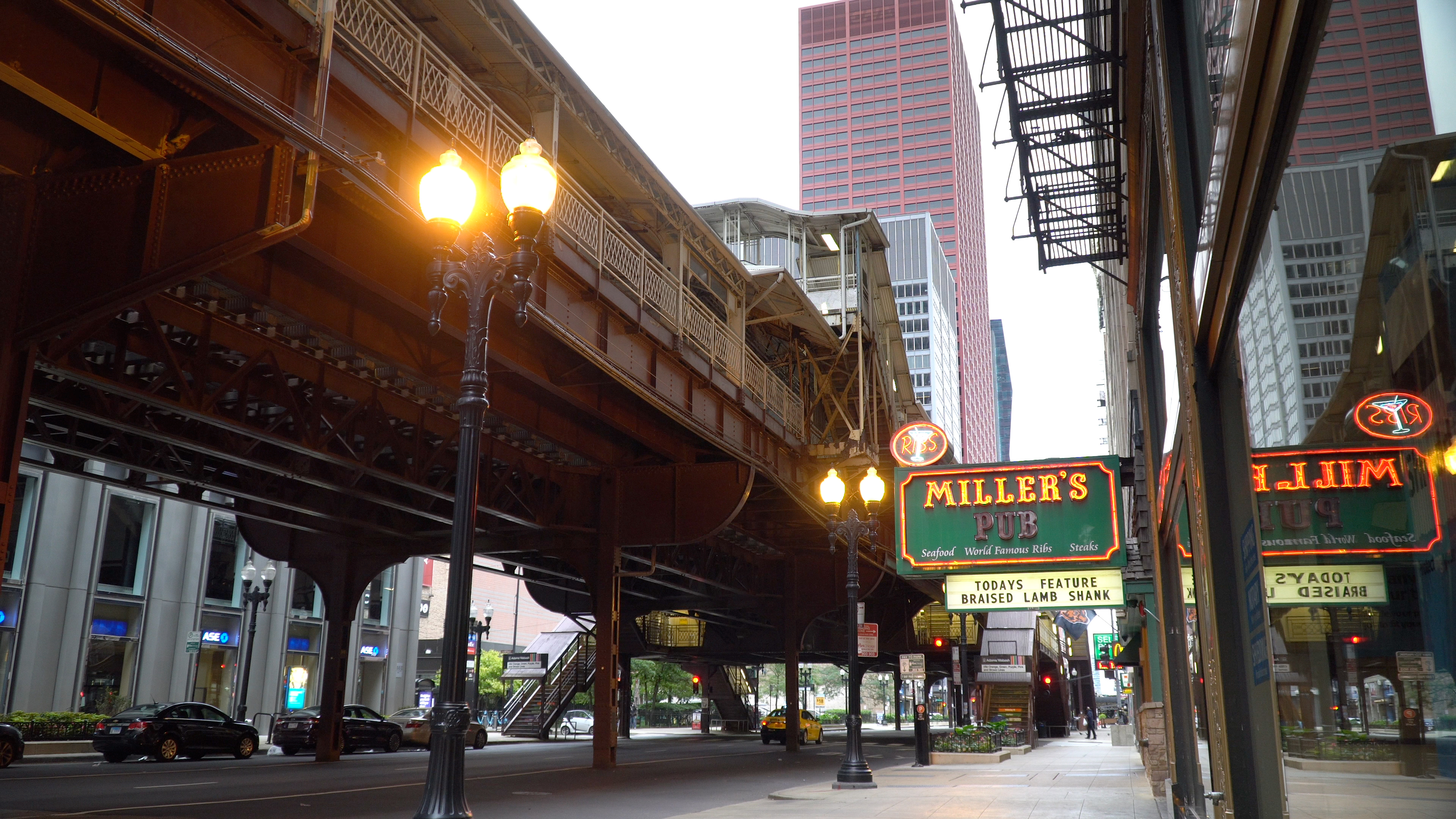 Outside Miller’s Pub in downtown Chicago near the elevated train track with a train passing.