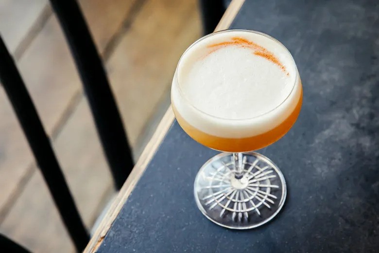 A whiskey sour on a table