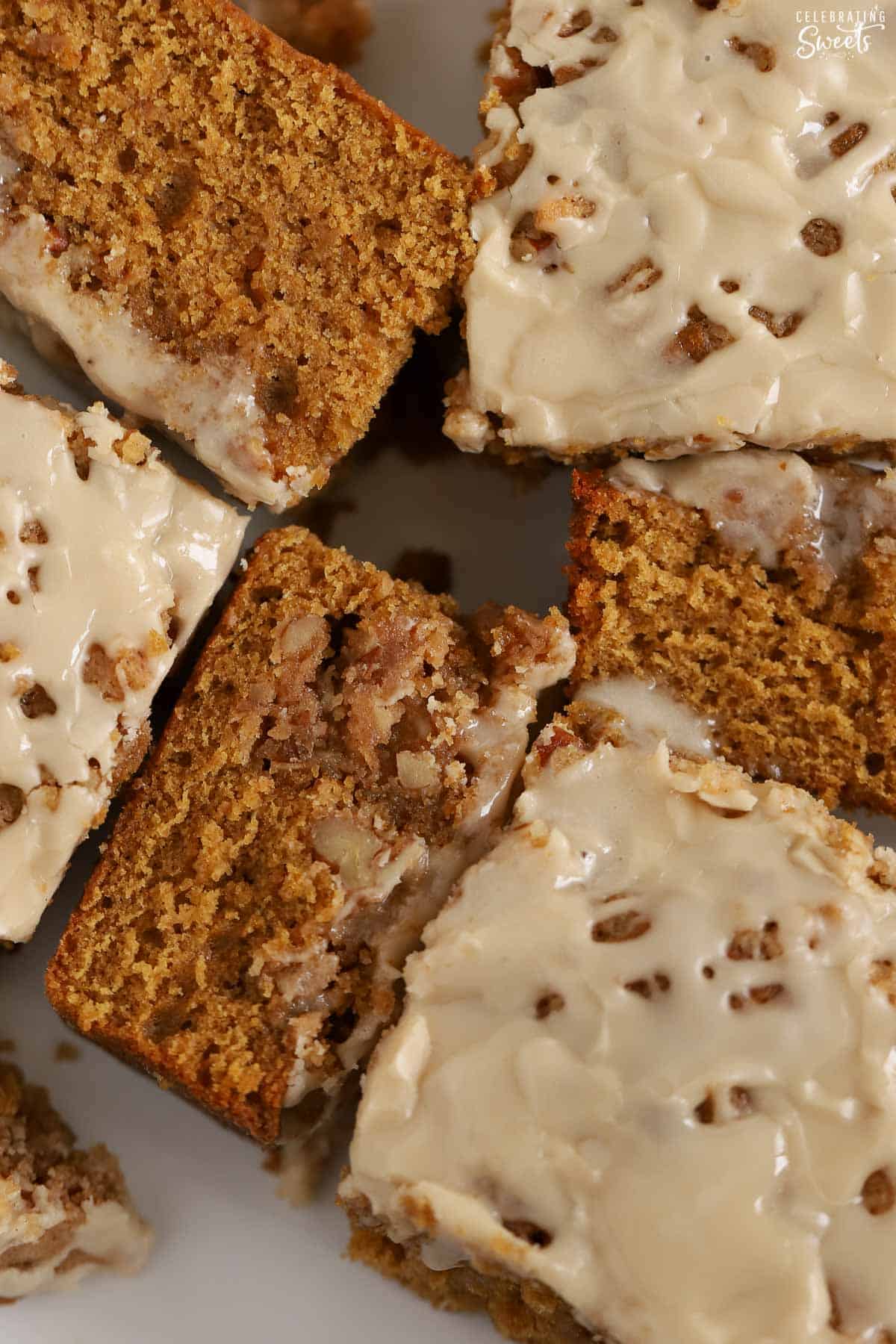 Six pieces of gingerbread cake on a white plate.