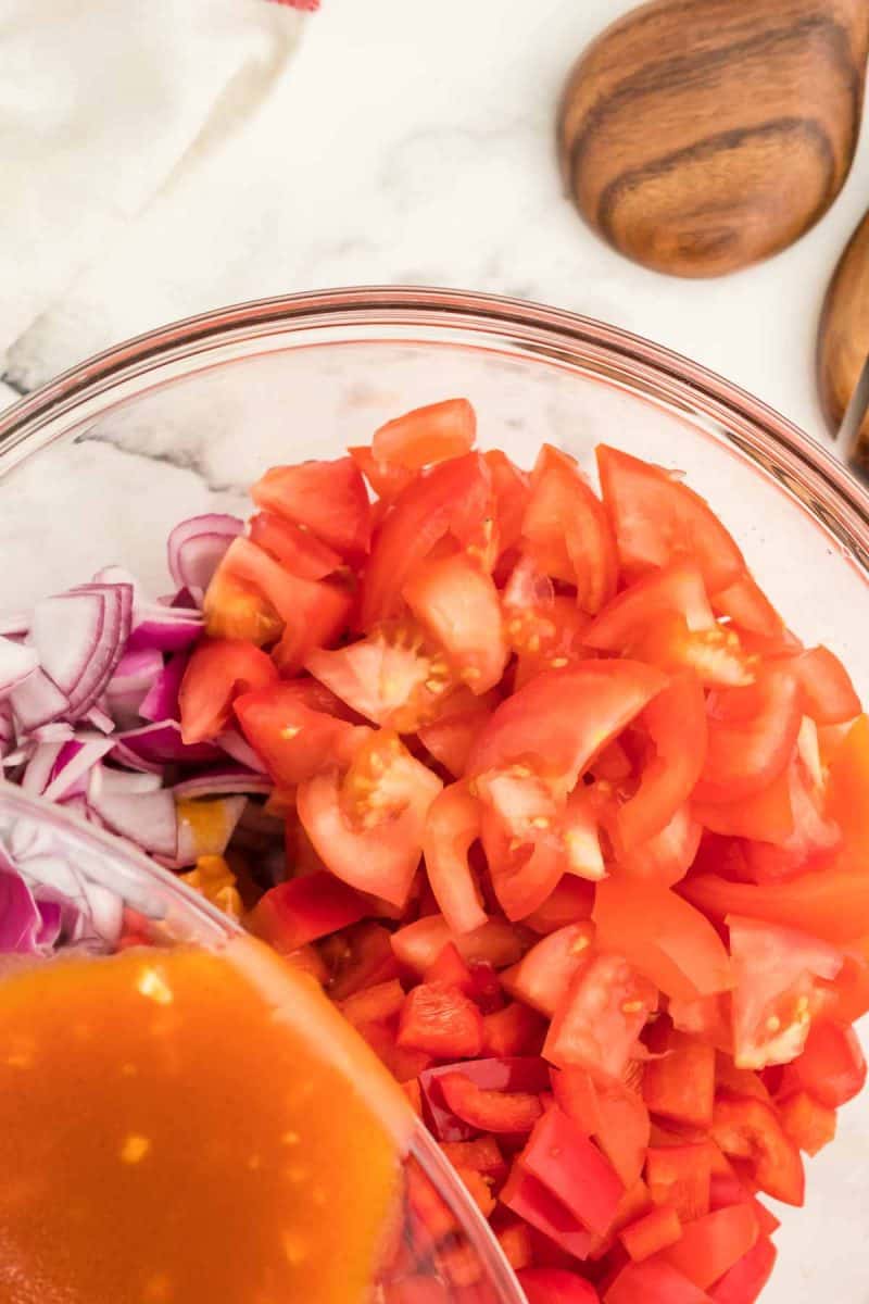 Pouring the dressing into the salad