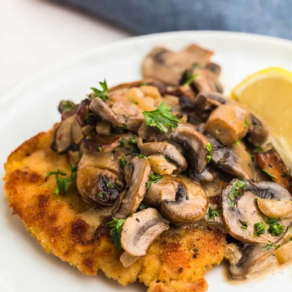 Jägerschnitzel served on a white plate.