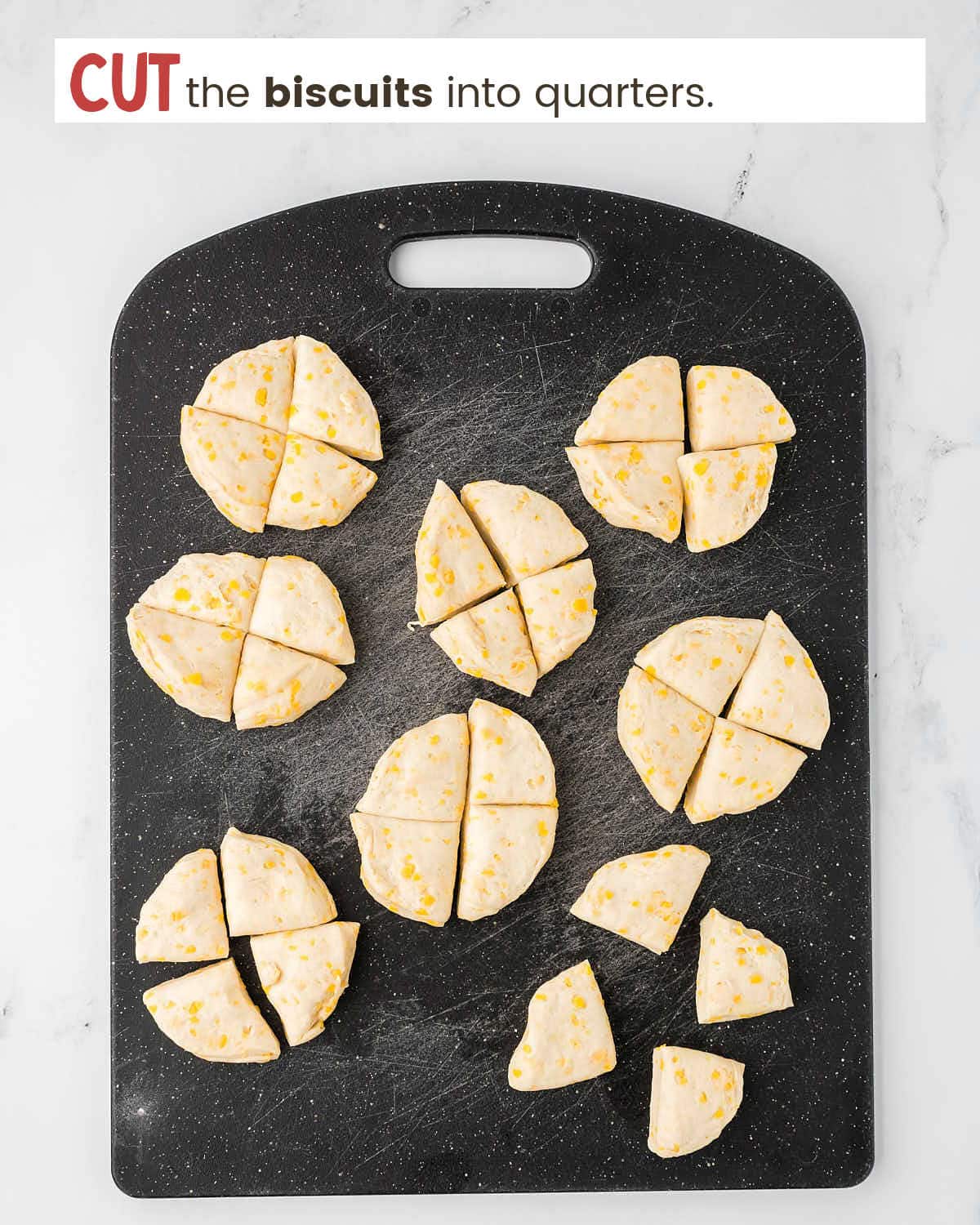 Quartered biscuits on a cutting board.