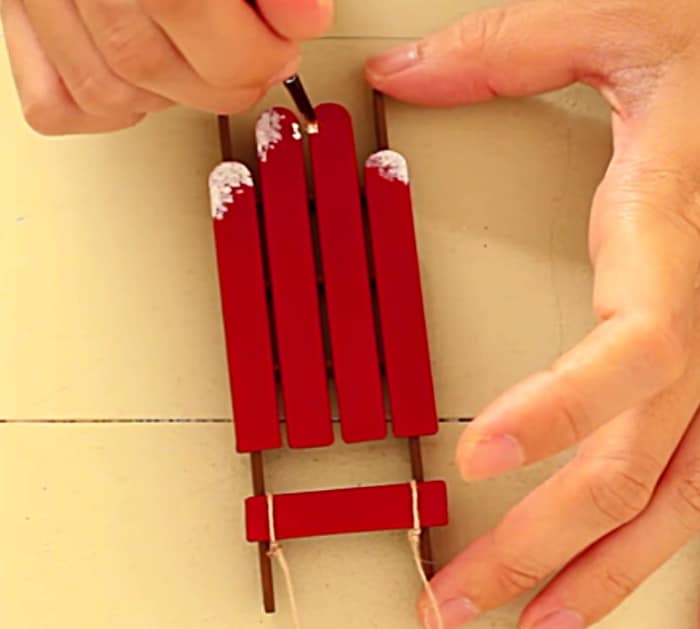 Try making a DIY Sled and Skis Ornament from popsicle sticks and craft paint