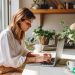 A woman sitting at her laptop about to start working on her blog.