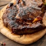 Grilled steak on a wooden cutting board.