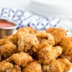 Fried gizzards on a plate with sauce.