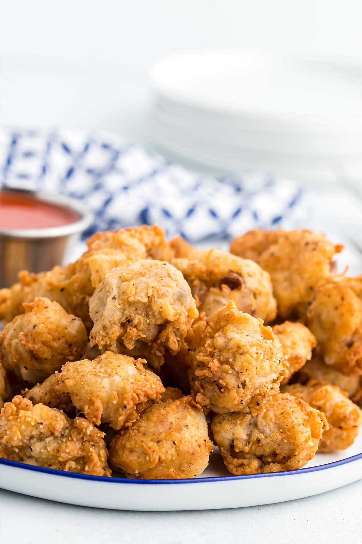 Fried gizzards on a plate with sauce.