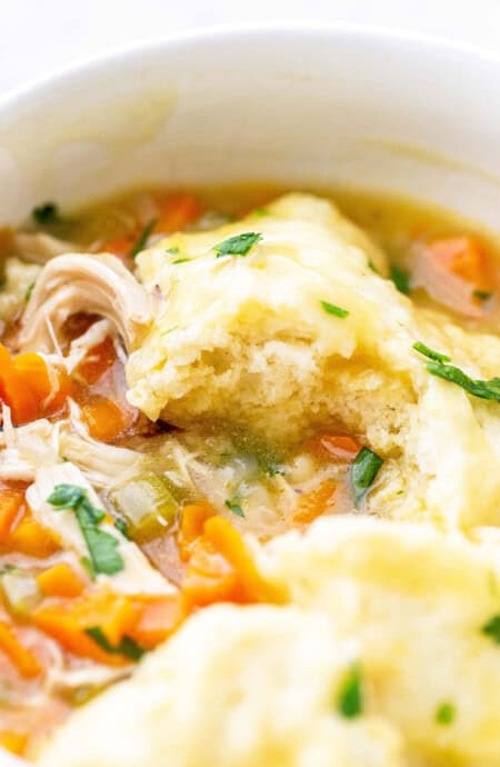 A large pot of homemade chicken and dumplings recipe ready to serve