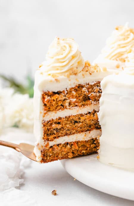 A slice of carrot cake sliding out to serve