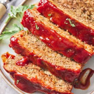 A close up of the most perfect meatloaf ever with slices ready to serve