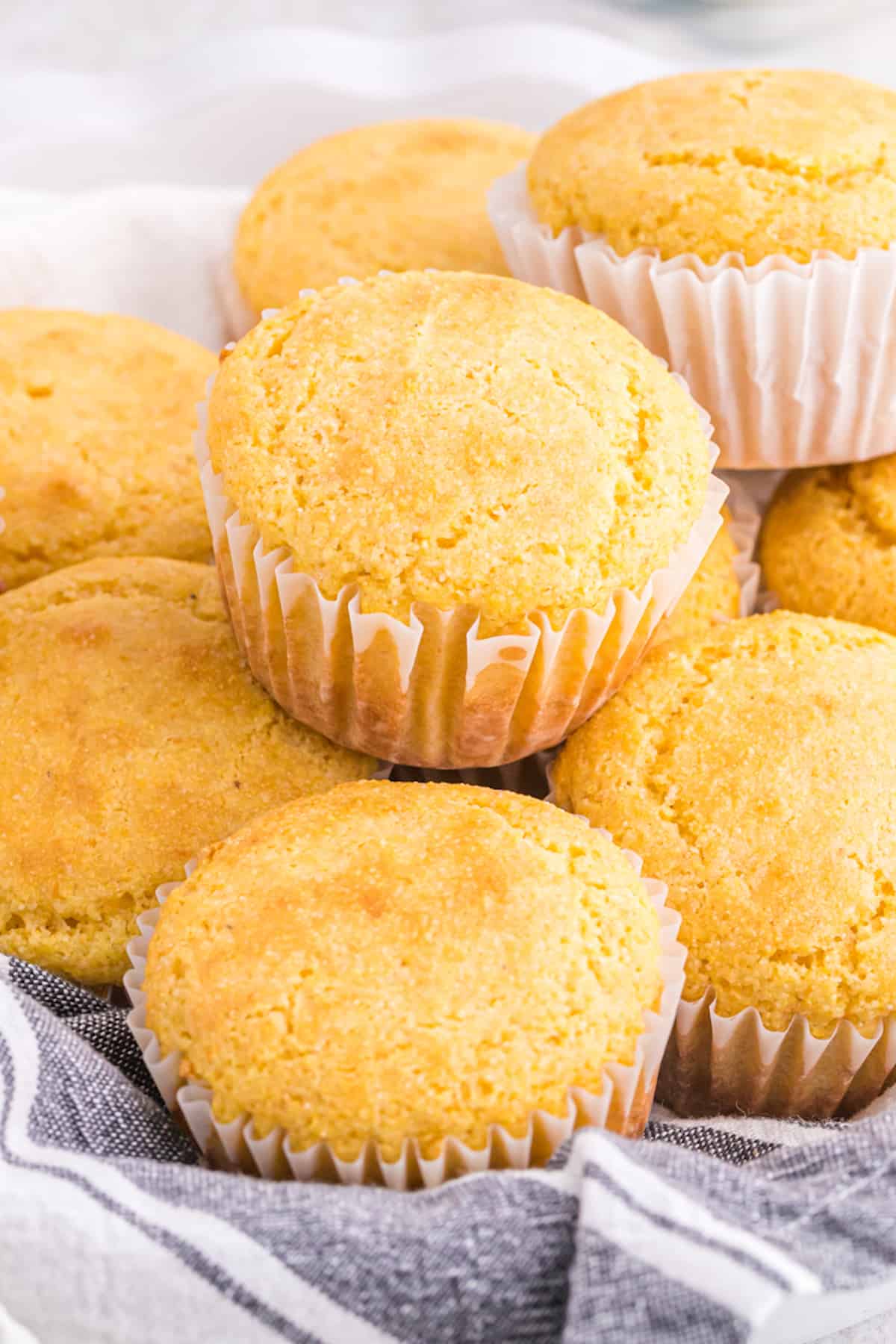 A close up of jiffy cornbread recipe muffins stacked on top of each other