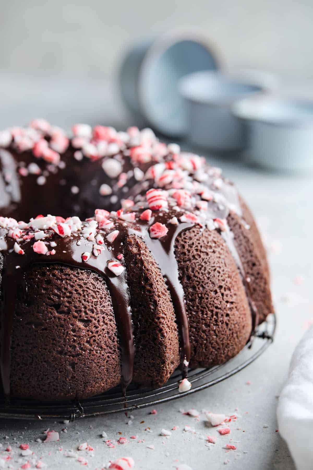 Ultimate Chocolate Pound Cake with Peppermint Ganache Glaze on a gray background