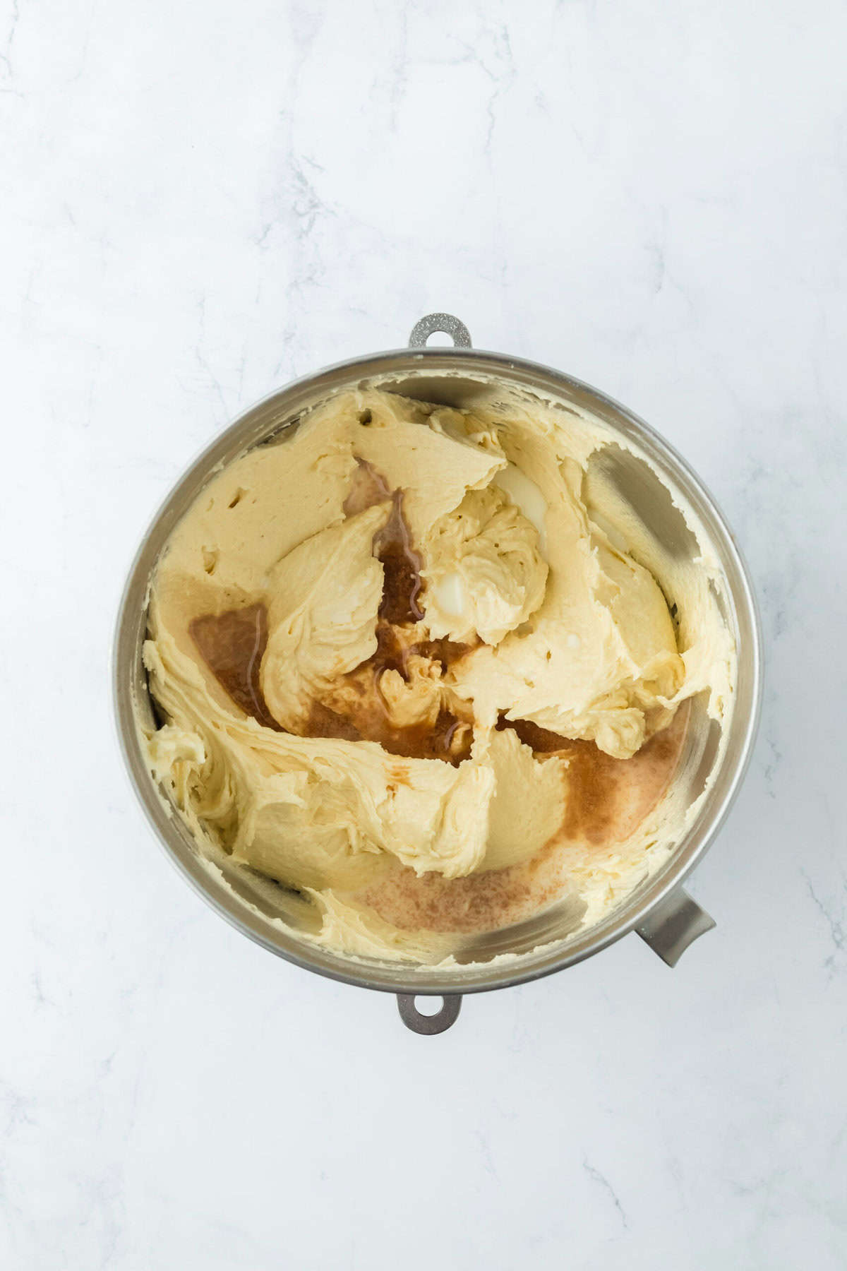 Vanilla added to the best pound cake batter in a stand mixer bowl