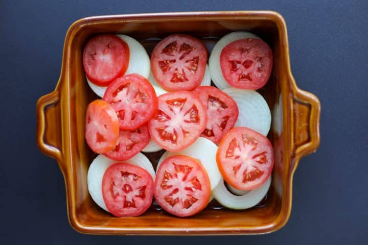 onions and tomatoes in a baking dish.