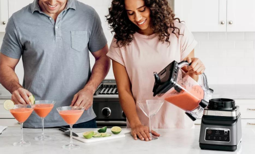 couple making frozen drinks with Ninja Professional Plus Duo blender