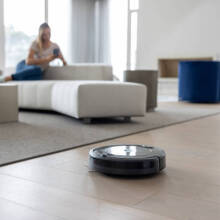 person using a robot vacuum