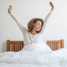 A women waking up in bed