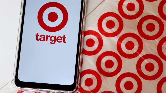 Bahia, Brazil - September 30, 2020.  Target Store logo on smartphone screen on top of Target shopping bag. Hypermarket. 