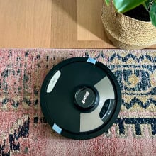 shark matrix plus 2-in-1 robot vacuum and mop on area rug near hardwood floor and indoor plant