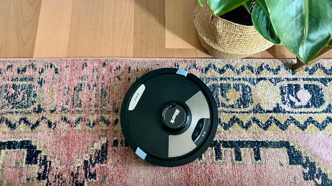 shark matrix plus 2-in-1 robot vacuum and mop on area rug near hardwood floor and indoor plant