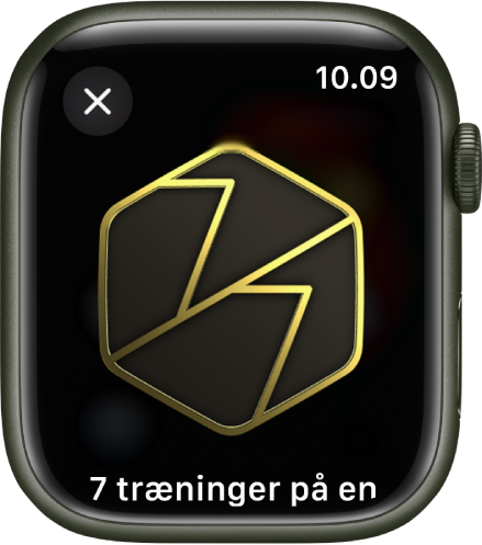 En præstationspræmie, der vises på Apple Watch. Under præmien er der en beskrivelse af præmien. Du kan rotere præmien ved at trække den.