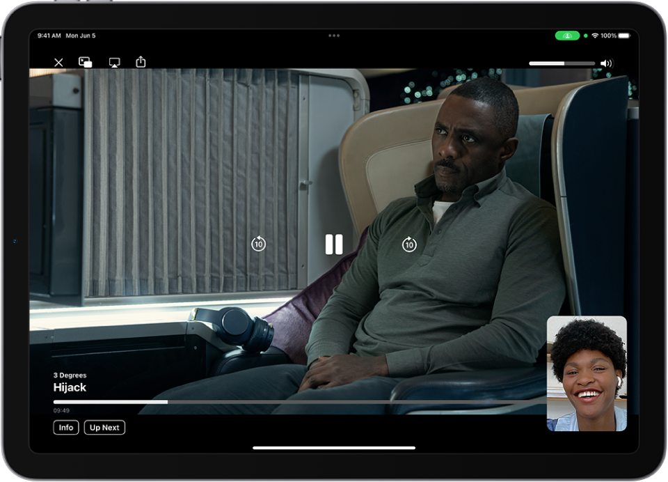 A FaceTime call showing a SharePlay session with Apple TV+ video content being shared in the call. The person sharing the content is shown in the small window, the video fills the rest of the screen, and the playback controls are on top of the video.