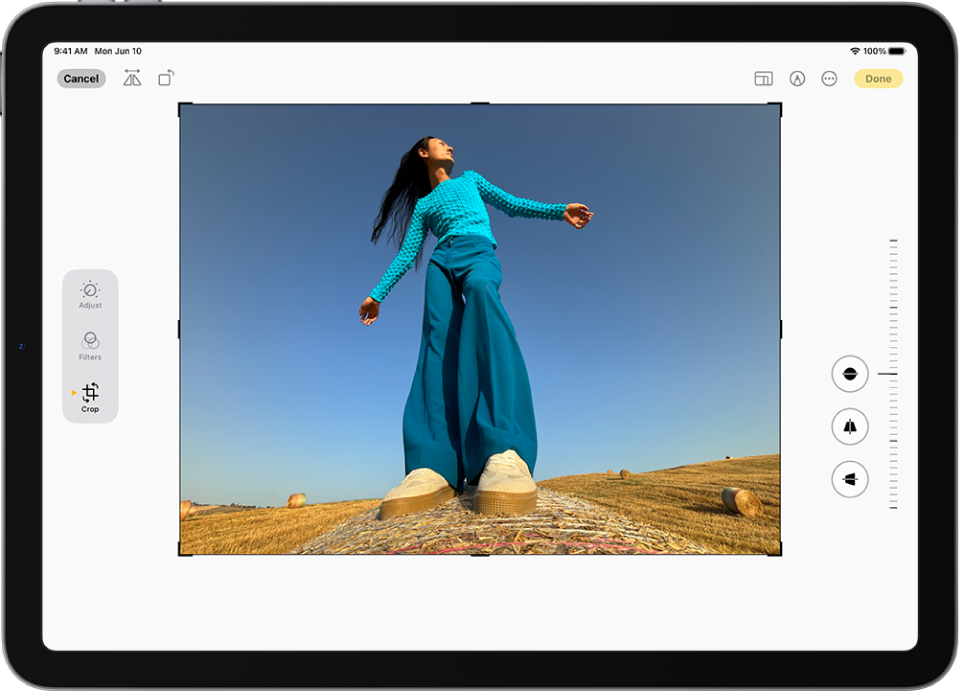 The Edit screen in the Photos app with a photo in the center. On the left side of the screen are the Adjust, Filters, and Crop buttons; the Crop button is selected. On the right side of the screen are the crop enhancement options and a slider to adjust the level of the effect.