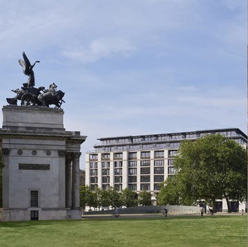 a large room with a large lawn and a large statue