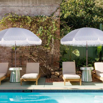 a pool with chairs and umbrellas