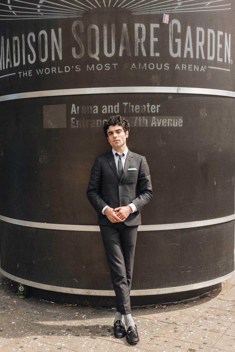 del water gap wearing a thom browne suit and gucci loafers