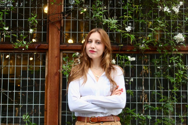 a woman standing in front of a window