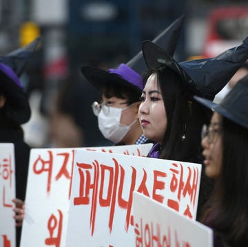 topshot south korean women dressed as witch hold placards supporting feminism during a protest to mark international womens day in seoul on march 8, 2019 photo by jung yeon je afp photo by jung yeon jeafp via getty images