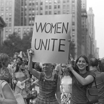 womens strike for equality a protest organized by the national organization for women, march in celebration of the fiftieth anniversary of the 19th amendment, for abortion on demand, equality in the workplace and free childcare an older and young woman hold up a sign women unite as they march down fifth avenue in new york city, new york photo by bob parentgetty images